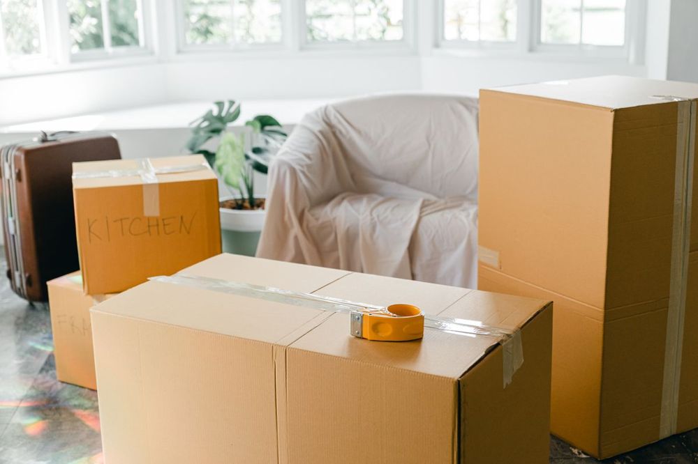 Moving boxes in a bright room in Meriden, CT before or after carpet cleaning